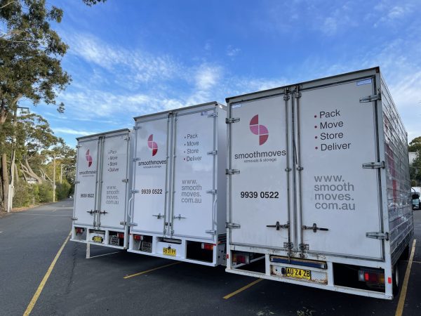 Three Smoothmoves removals trucks parked next to each other