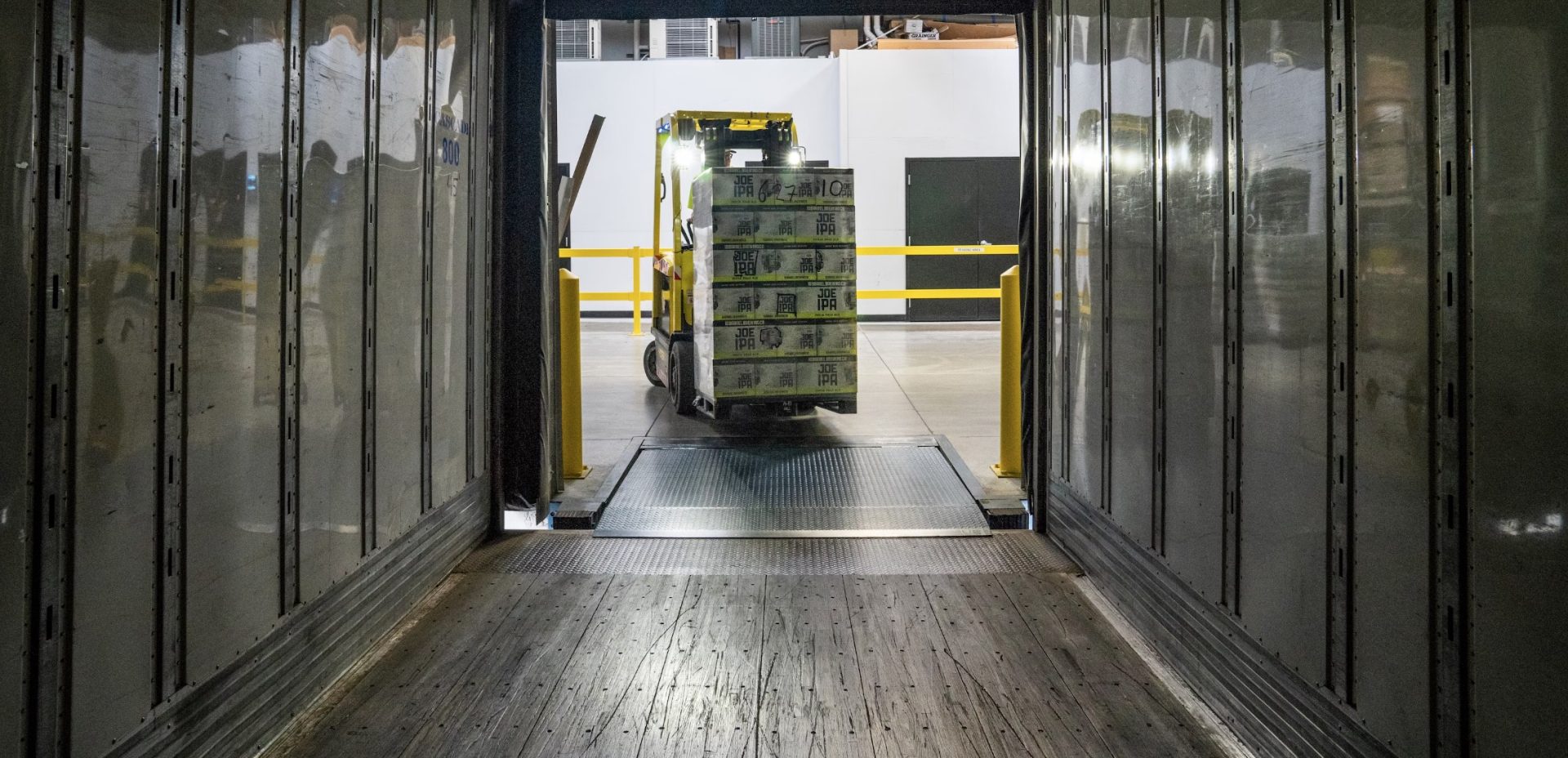 View from inside a Smoothmoves truck, forklift removing some moving boxes